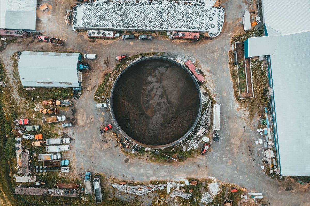 Aerial view of a large industrial facility with storage tanks and processing infrastructure for biomethanol production.